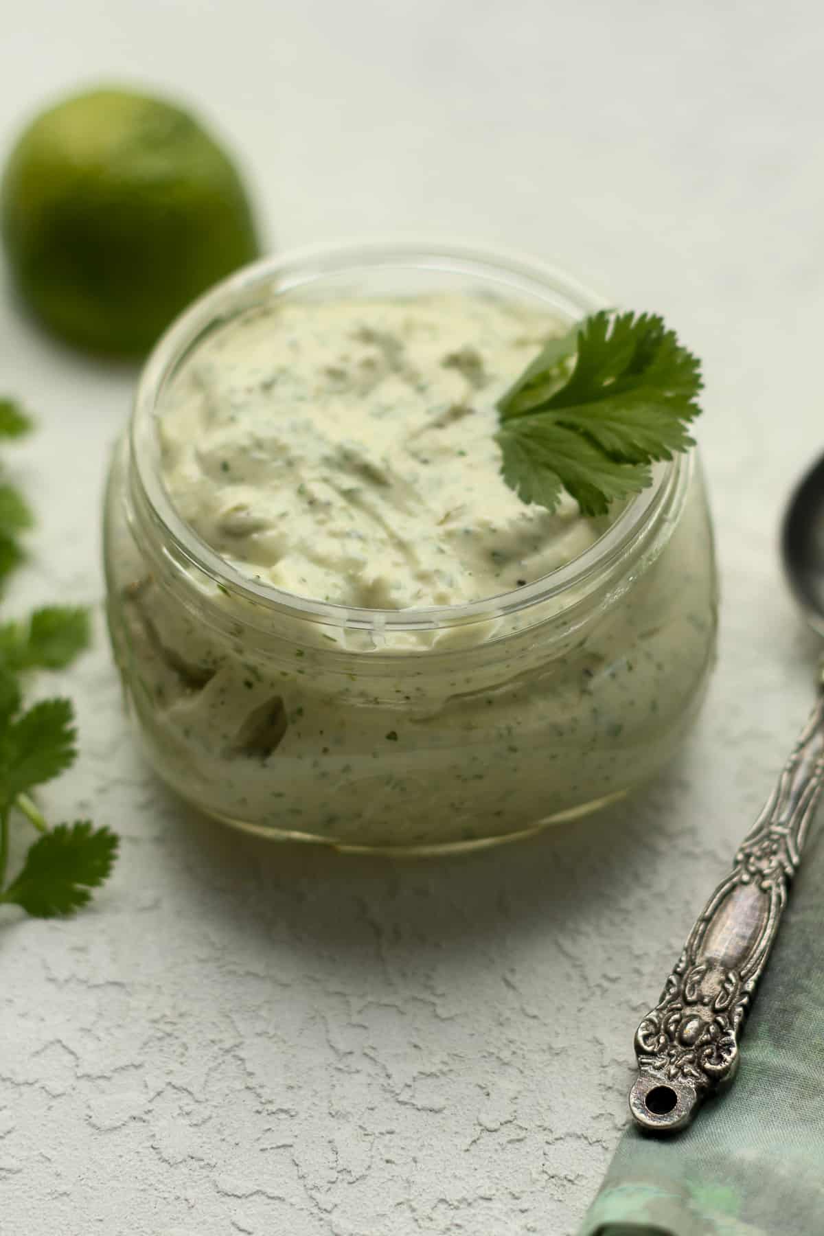 Side view of a jar of ranch dressing with jalapeno.