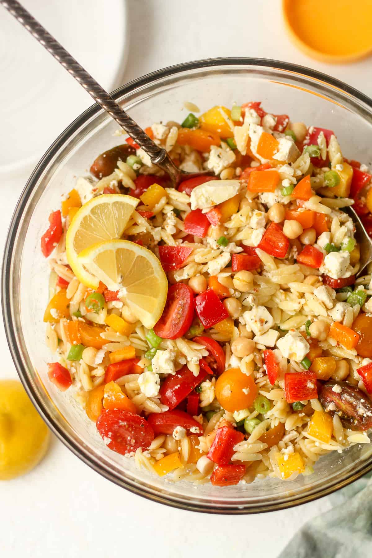 A large bowl of orzo pasta salad with lemon dressing.