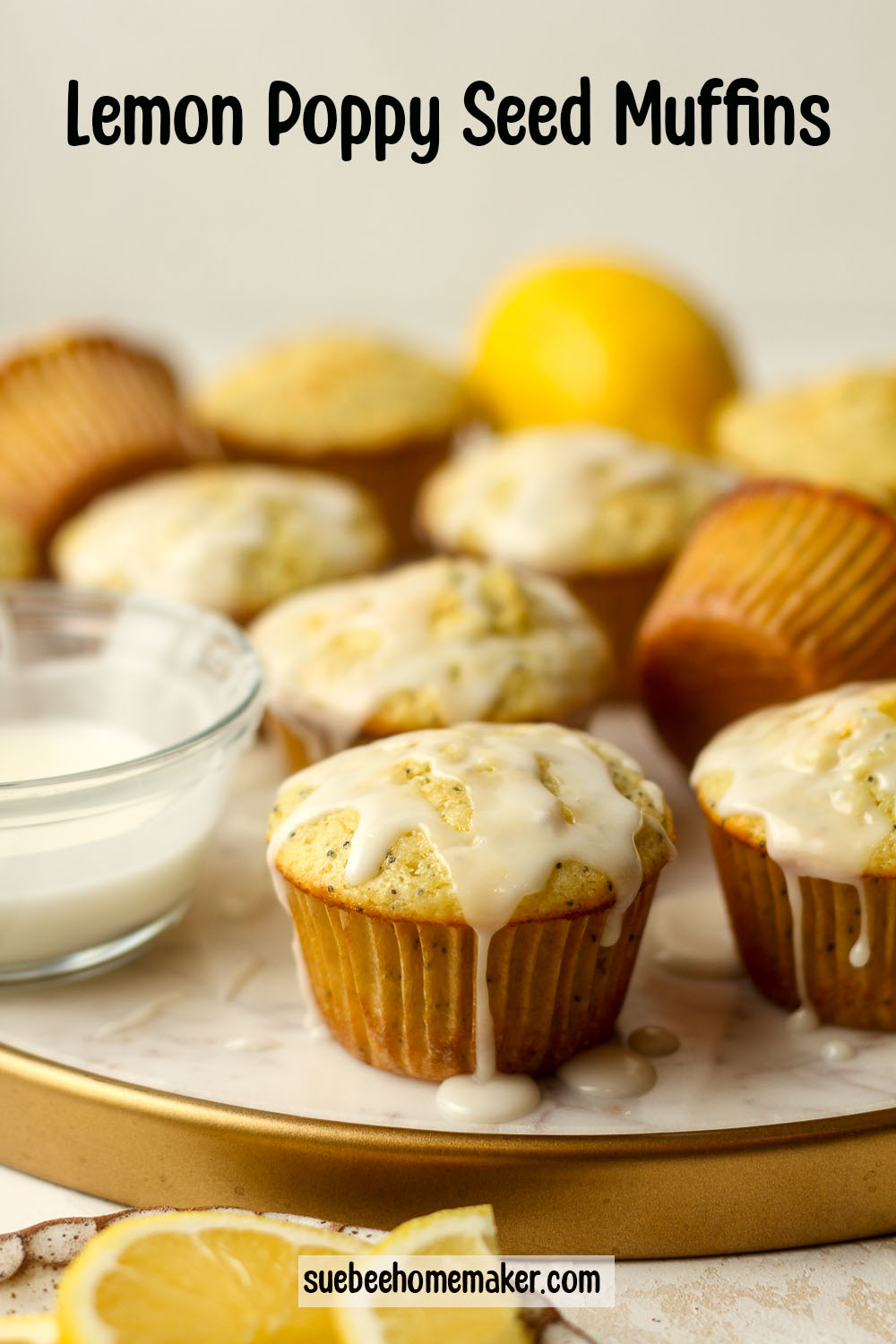 Side view of a tray of lemon poppy seed muffins with a glaze.
