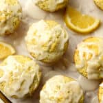 A closeup on glazed lemon muffins with poppy seeds.