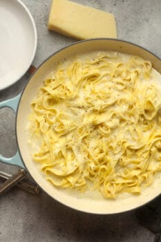 A pot of skinny Alfredo sauce on pasta.