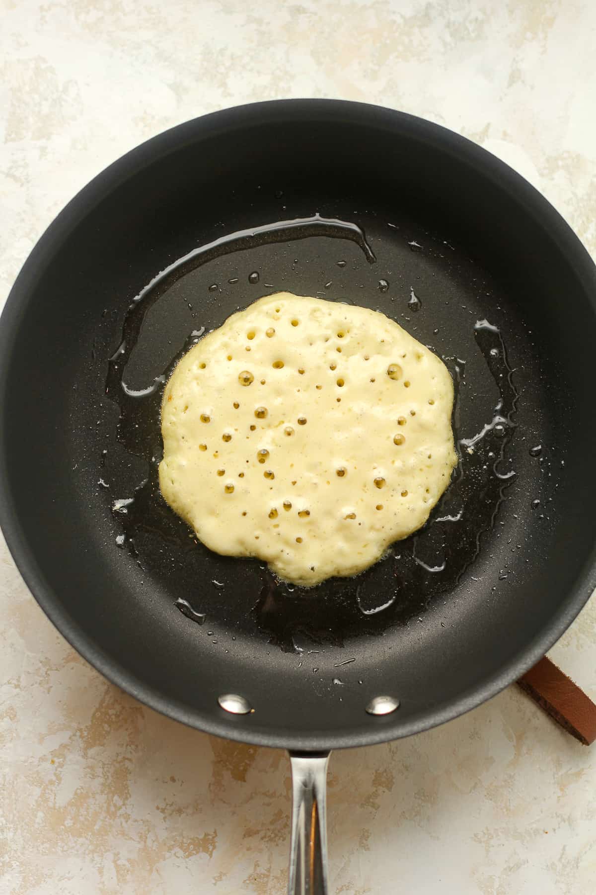 A pan with a pancake that's cooking.