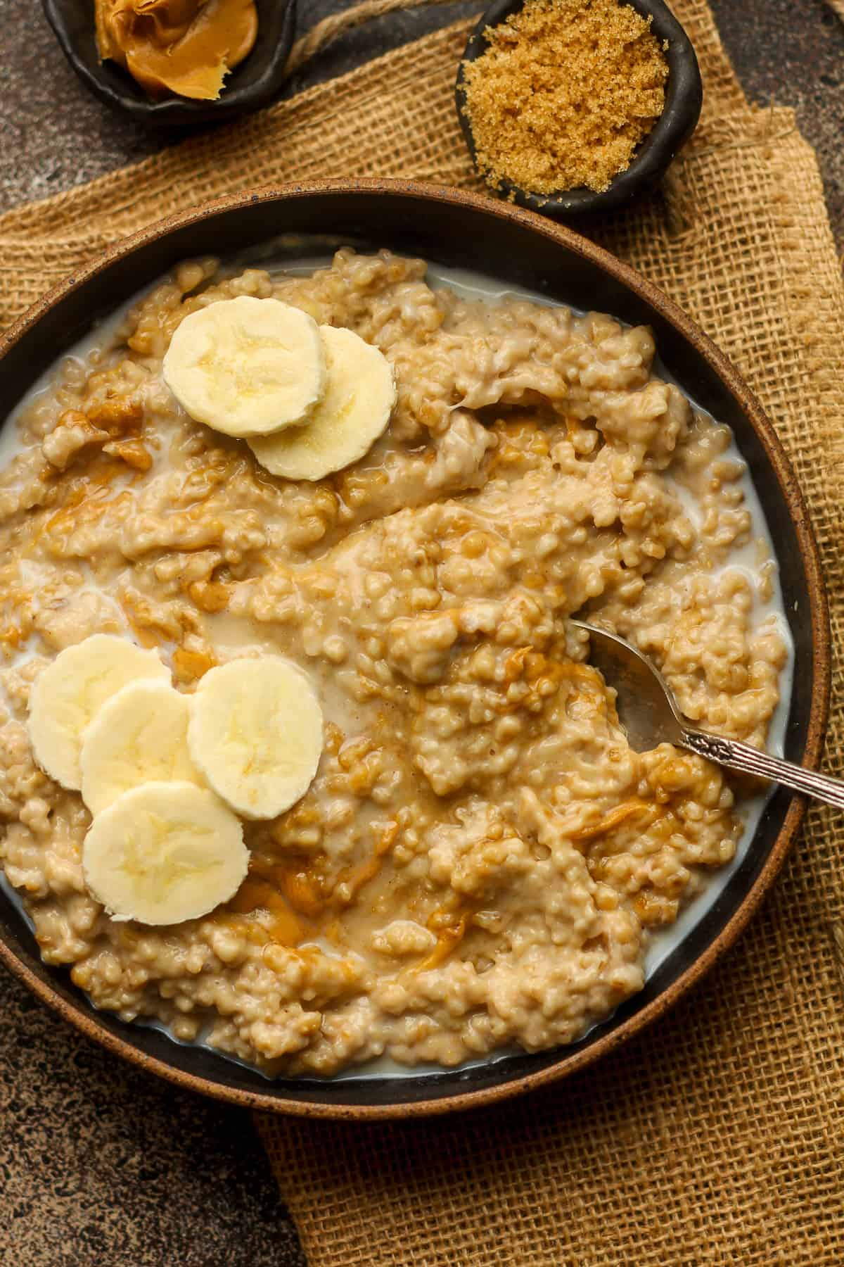 Closeup on a bowl of steel cut oats with banana slices.