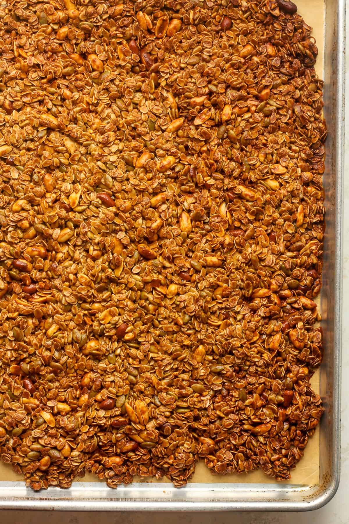 The just baked granola on a sheet pan.