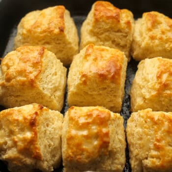 Closeup on a skillet of buttery biscuits.