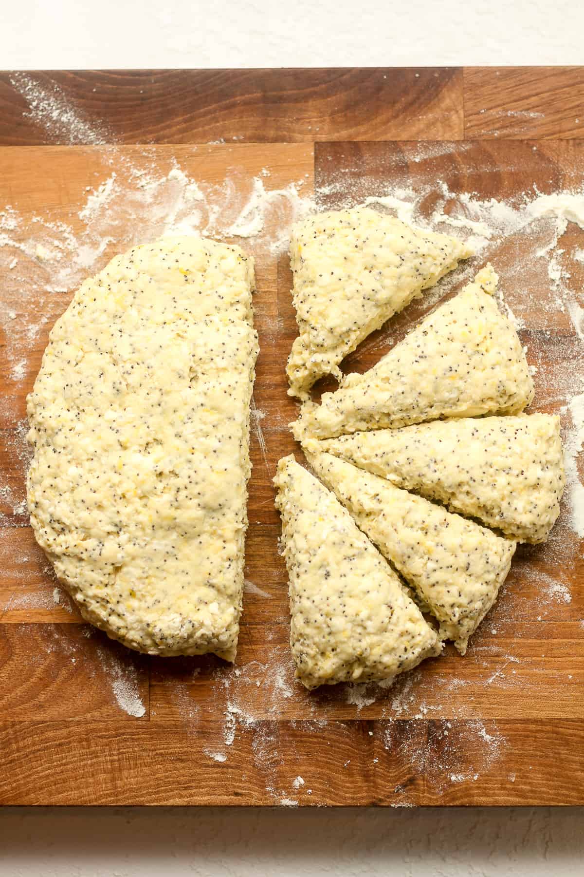 A board of the sliced lemon poppyseed scone dough.