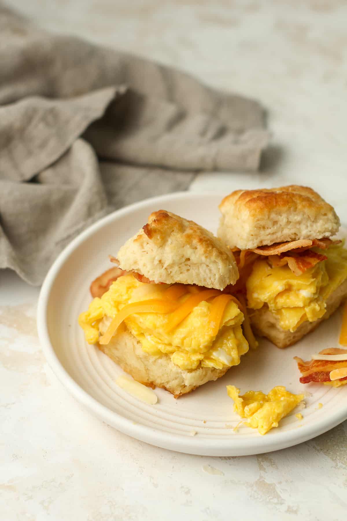 Side view of two breakfast biscuit sandwiches.