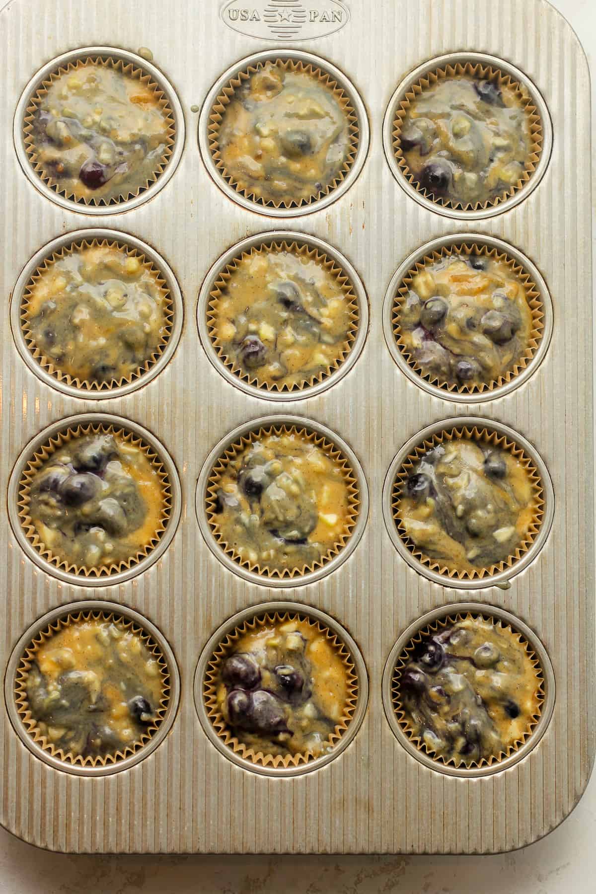 The muffin batter in the muffin tins.