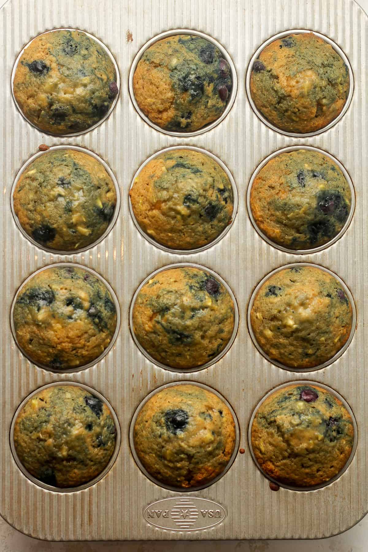 A muffin tin of just baked muffins.