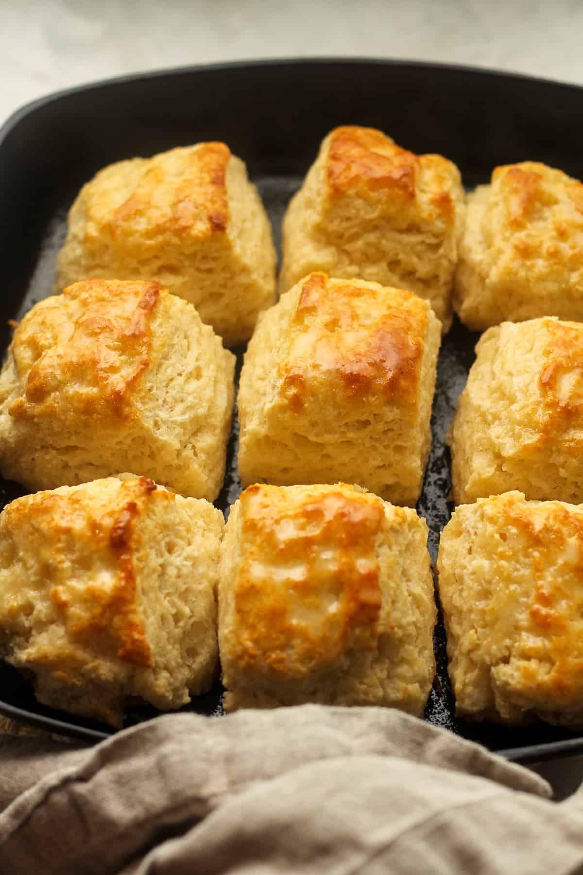Side view of a skillet of buttermilk biscuits.