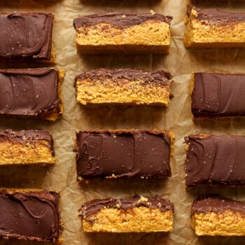 Some sliced no bake peanut butter bars with a chocolate topping.