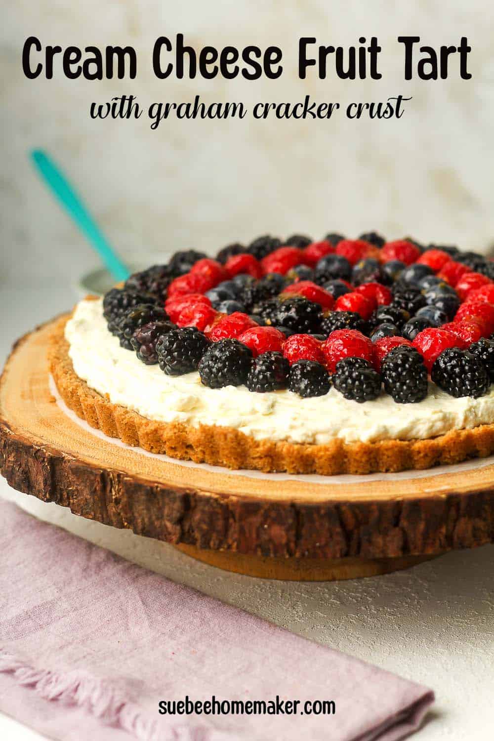 Side view of a tray of cream cheese fruit tart.