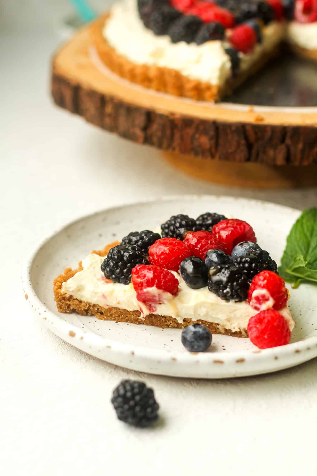 A plate with a slice of berry fruit tart.