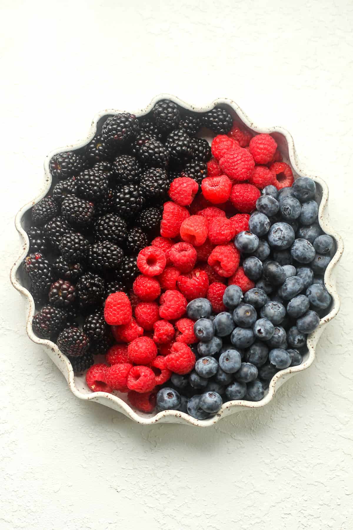 A plage of berries - blackberries, raspberries, and blueberries.