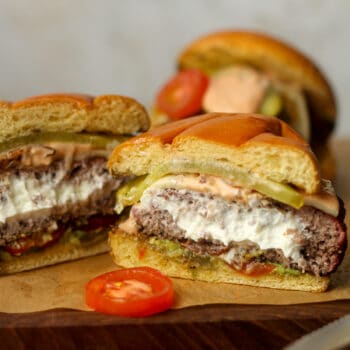 A goat cheese burger split in half showing the stuffed inside.