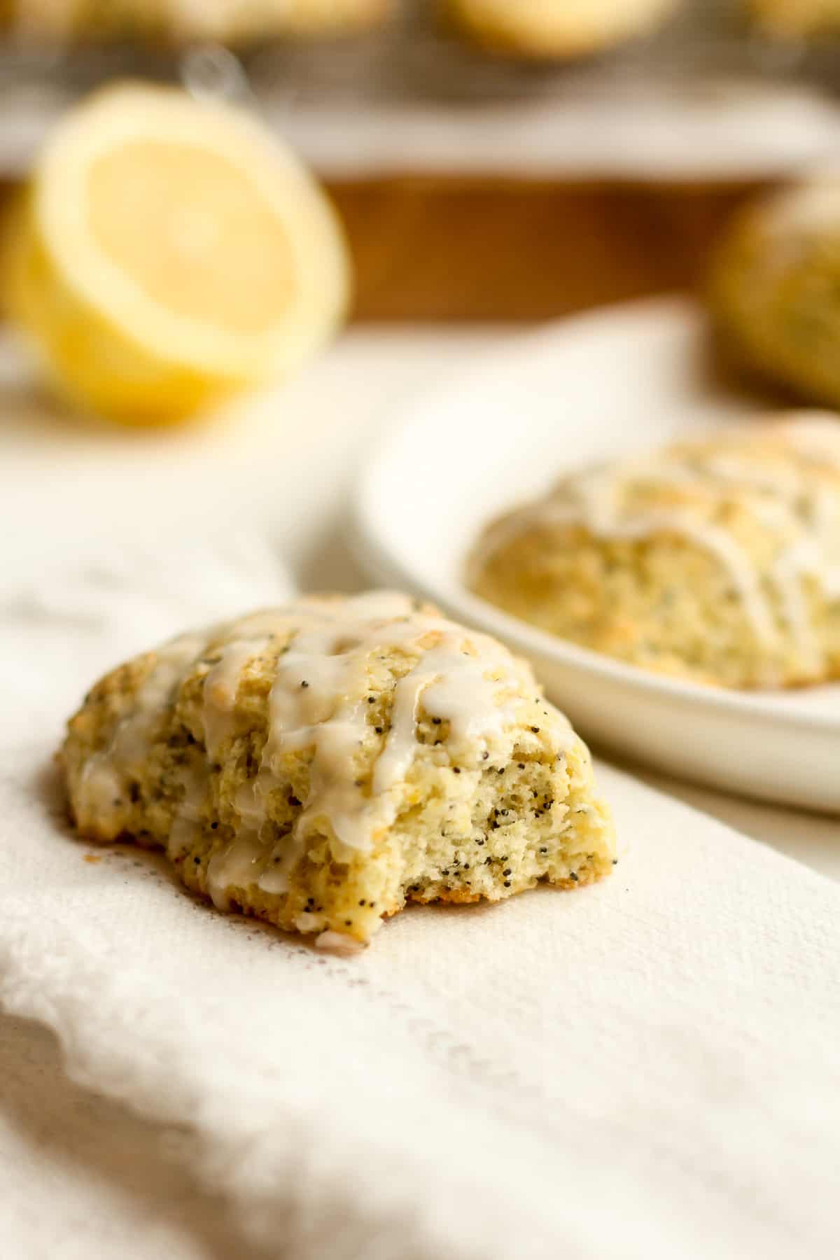 Closeup on a lemon poppy seed scone with a bite missing.