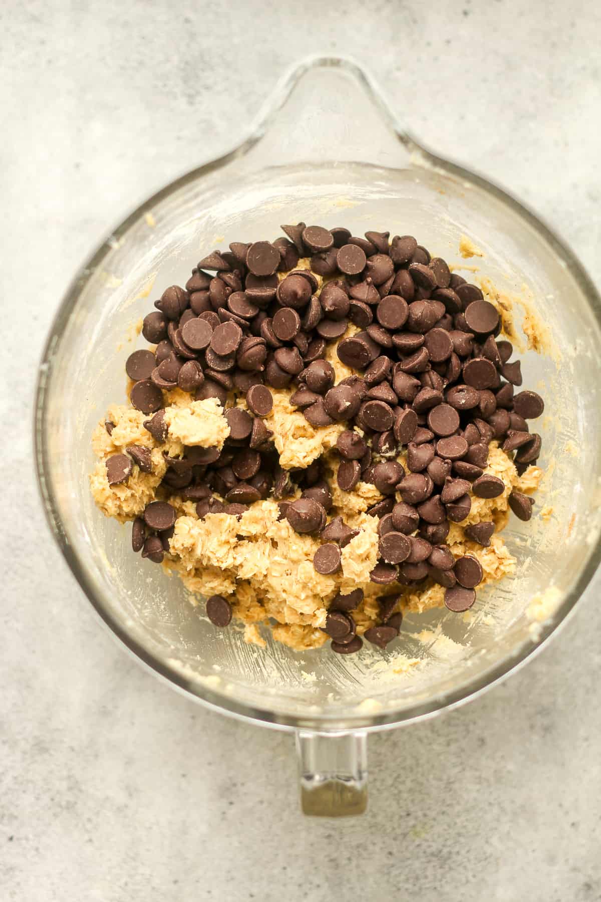 The mixing bowl with the batter plus chocolate chips on top.