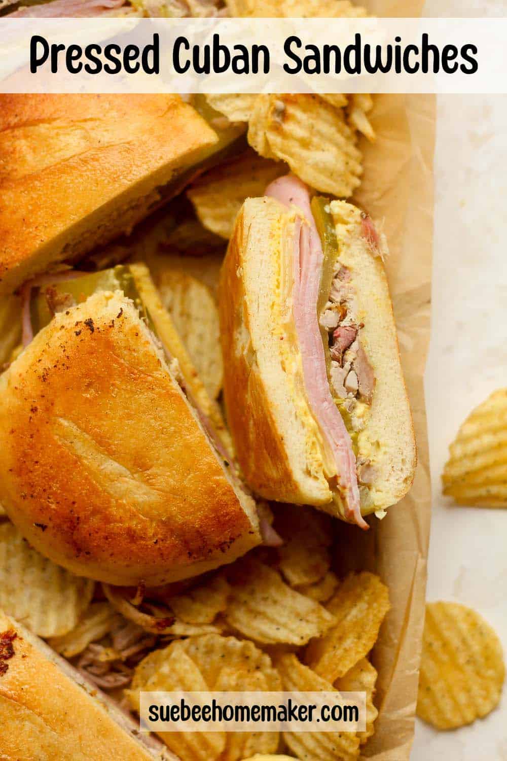 A pan of pressed Cuban sandwiches with chips.