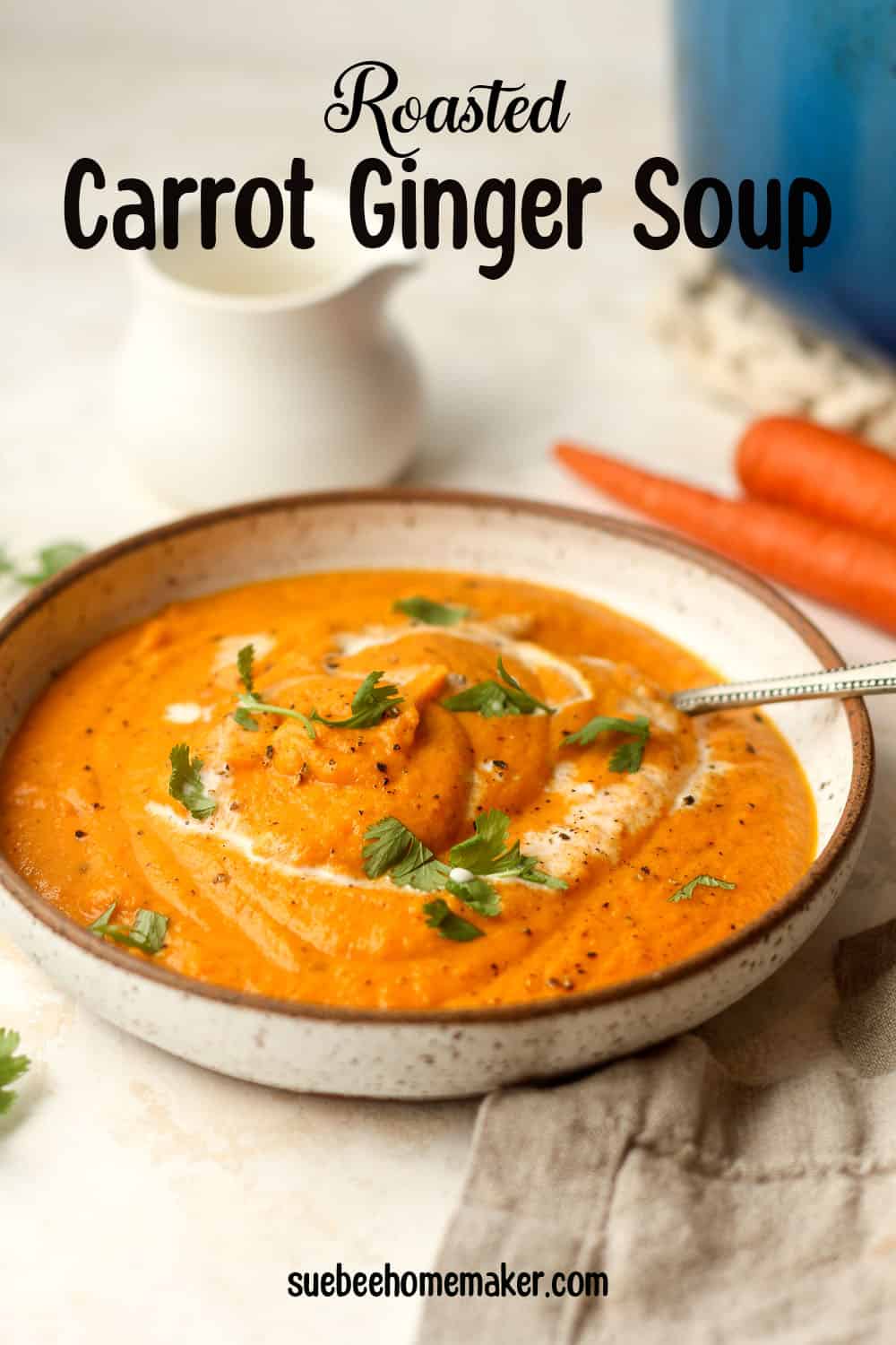 Side view of a bowl of roasted carrot ginger soup.