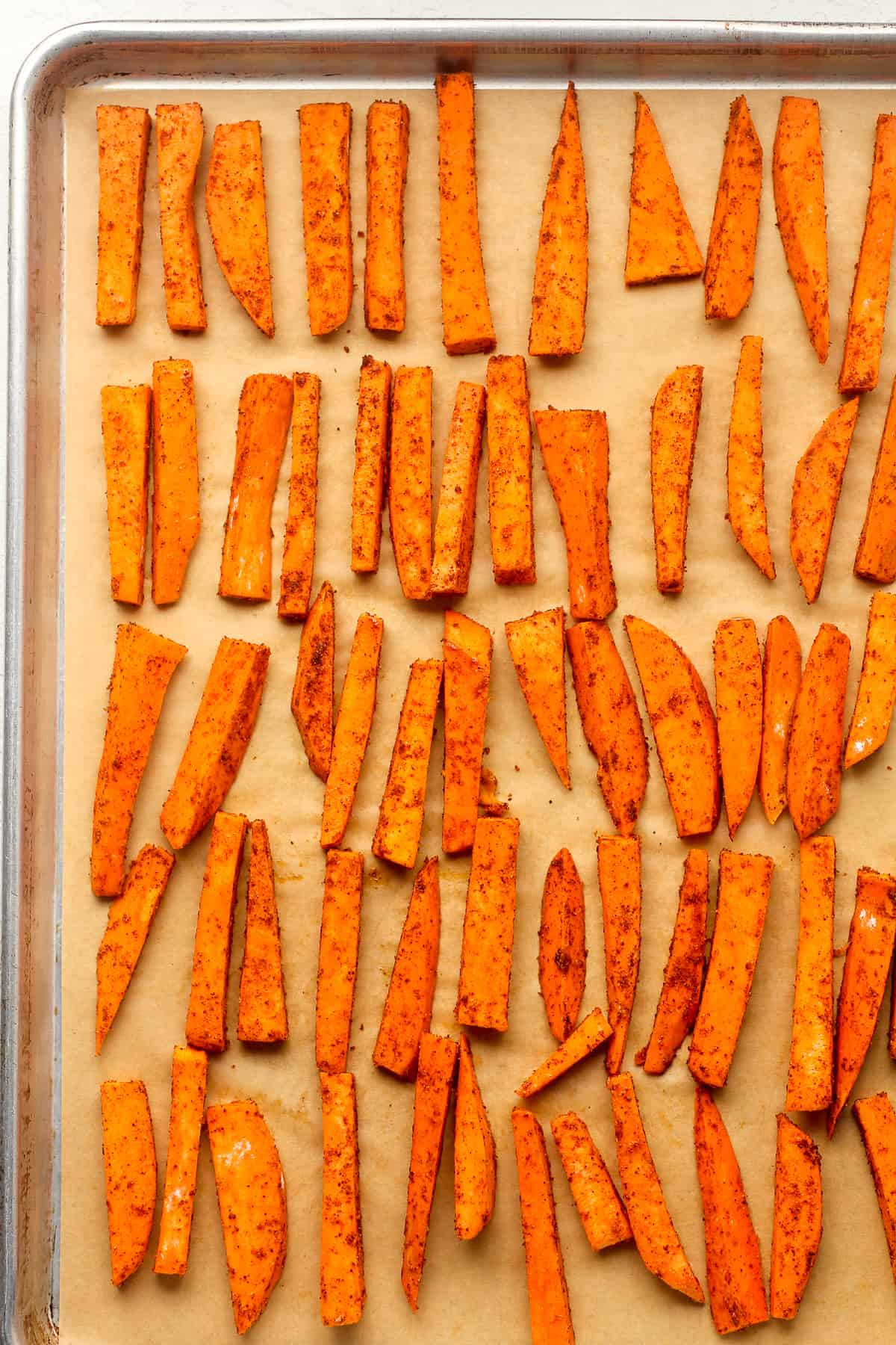 A pan of the sweet potato fries before baking.