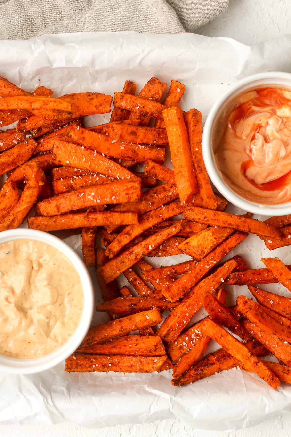 Overhead view of some sweet potato fries with sauce.