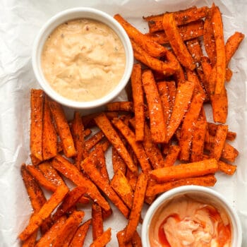 A tray of sweet potato fries with salt added.