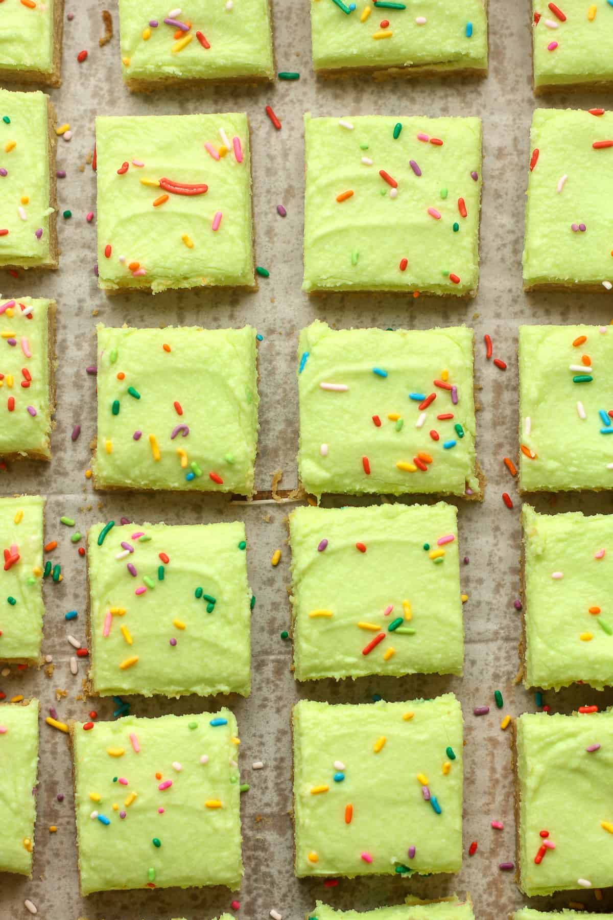 Overhead view of blondie squares with neon green buttercream.