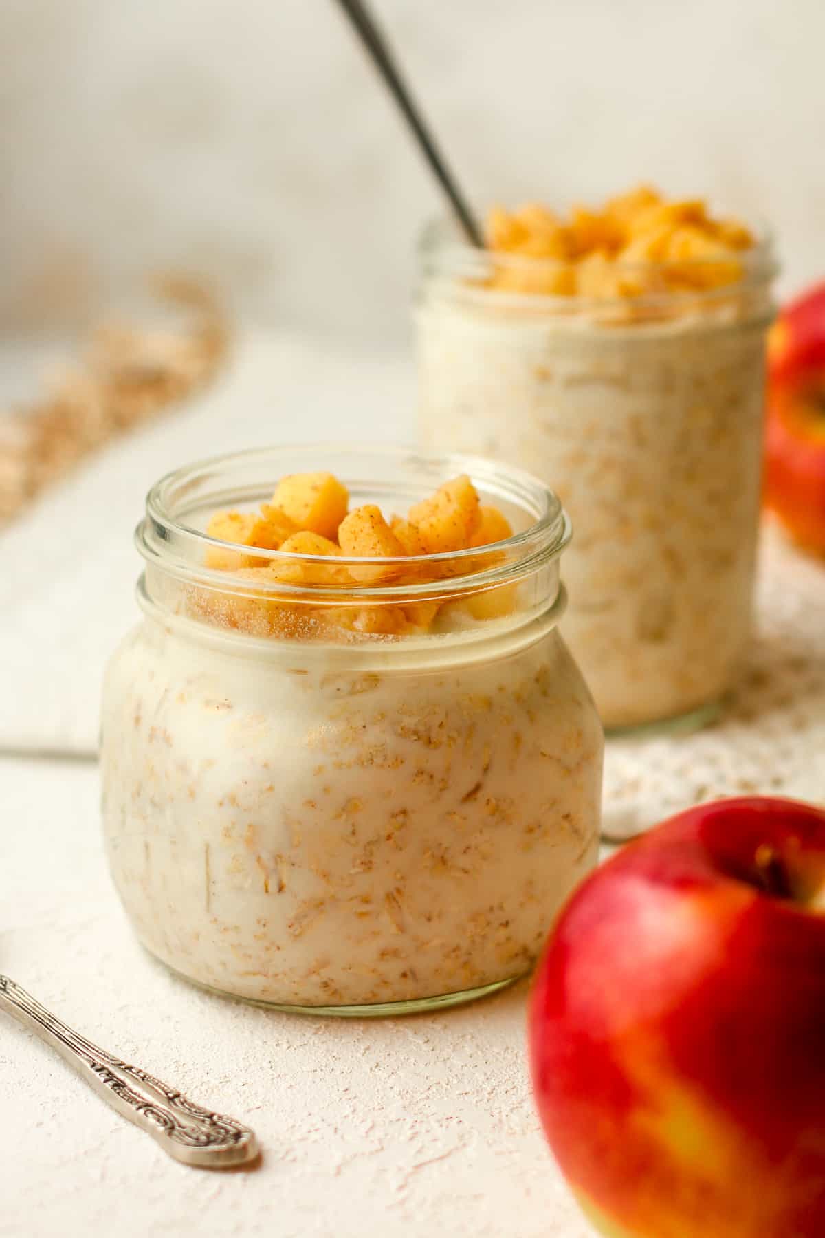 Side view of two jars of cinnamon apple overnight oats.