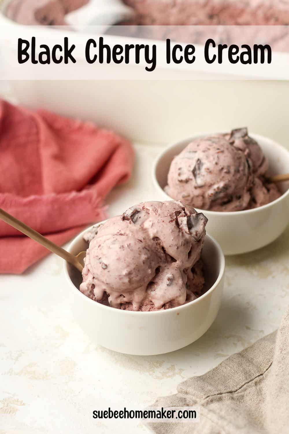 Two bowls of black cherry ice cream with a bright pink napkin.