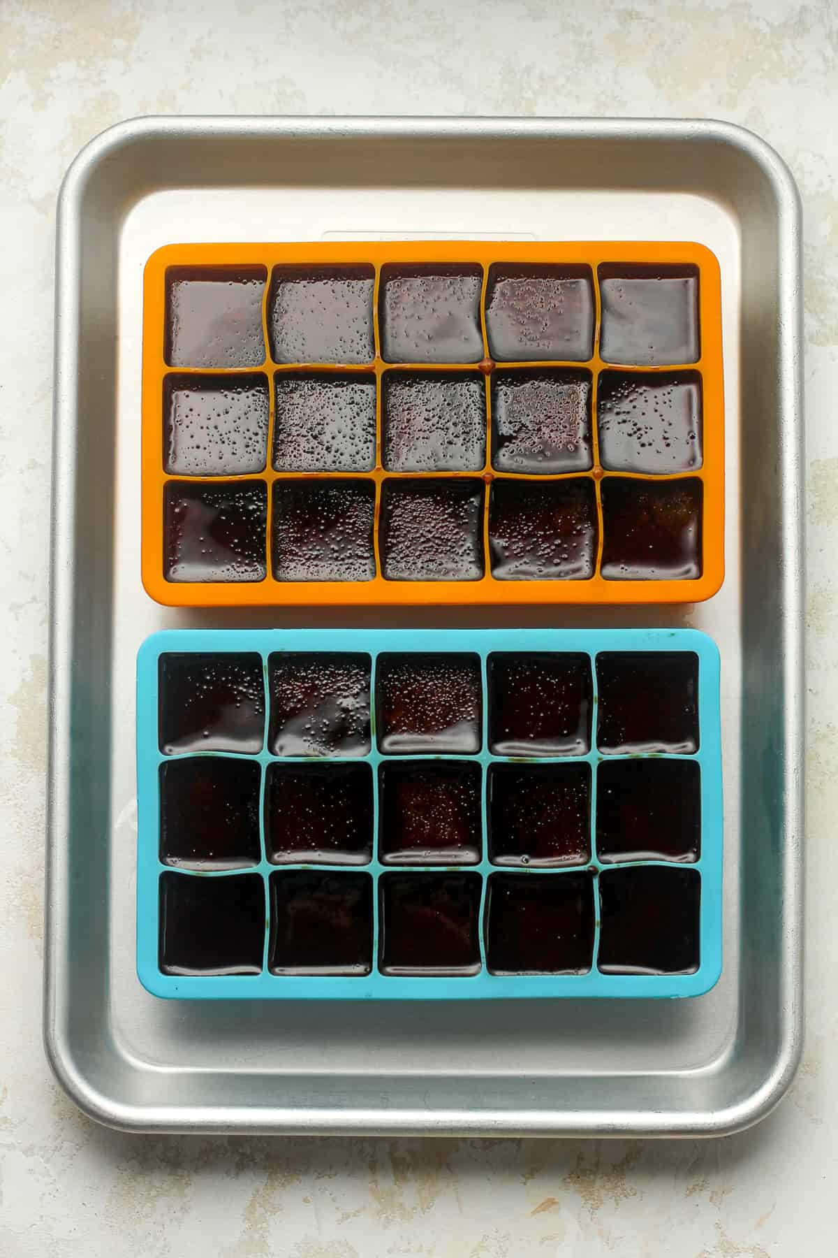 Two trays of coffee cubes.
