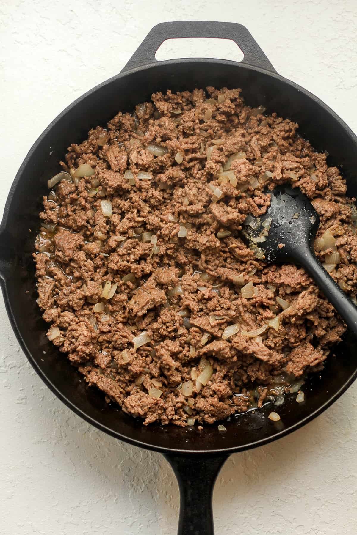 A skillet of the browned beef mixture.