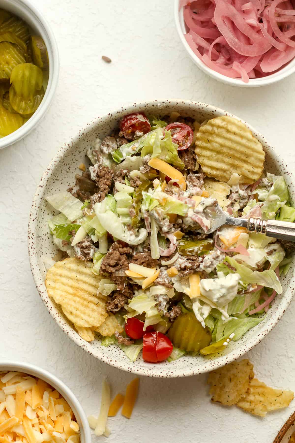 A bowl of the burger salad with dill pickle ranch.