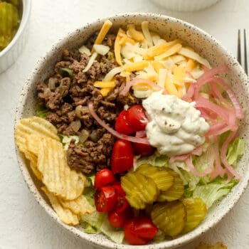 A serving bowl of the burger bowl ingredients, separated by ingredient.