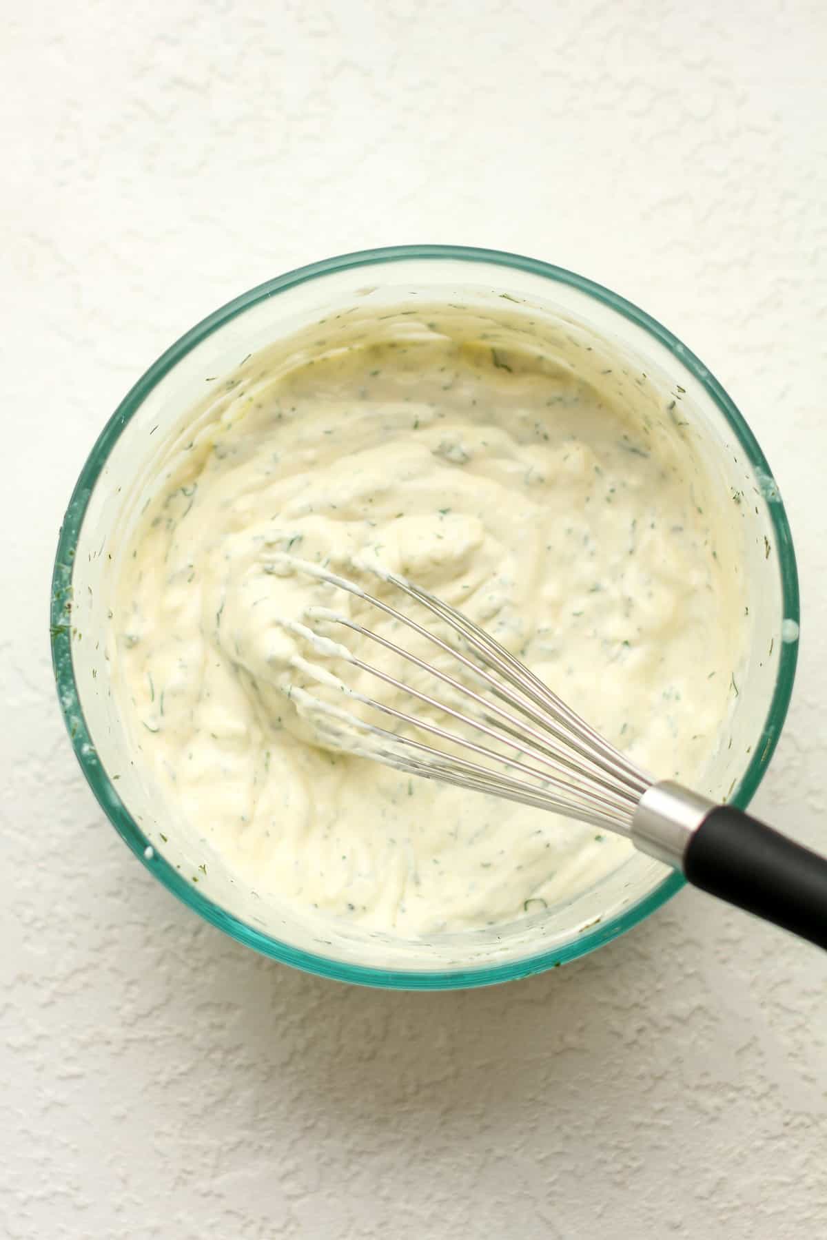 A bowl of the whisked ranch dressing.