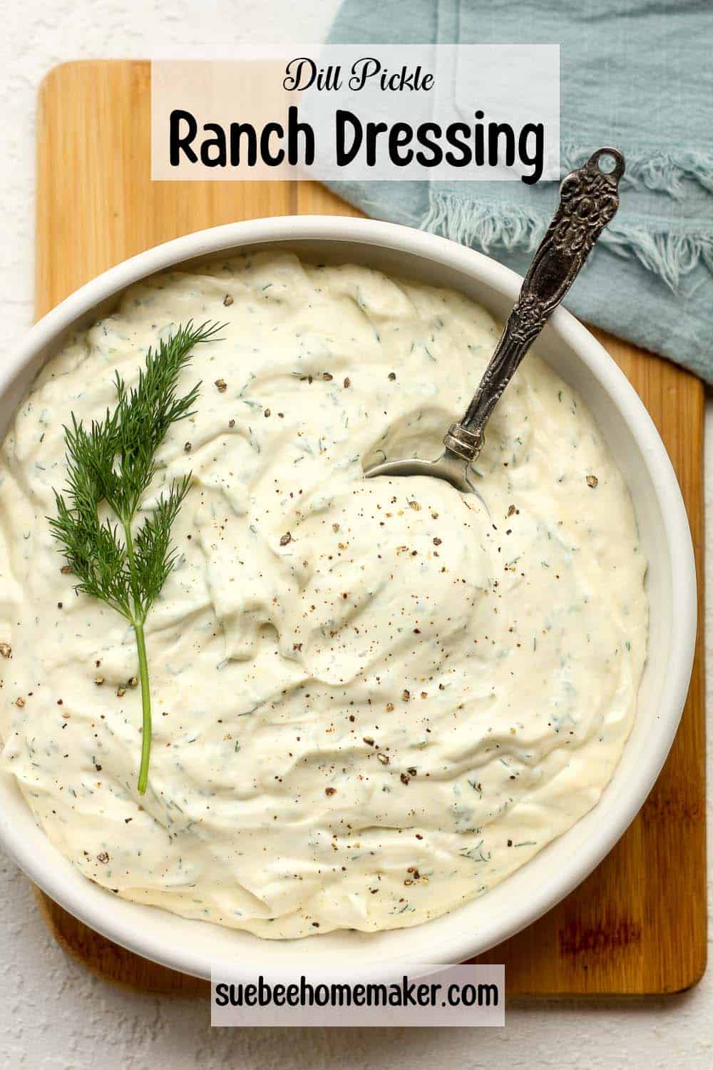 A bowl of dill pickle ranch dressing with a tablespoon inside.
