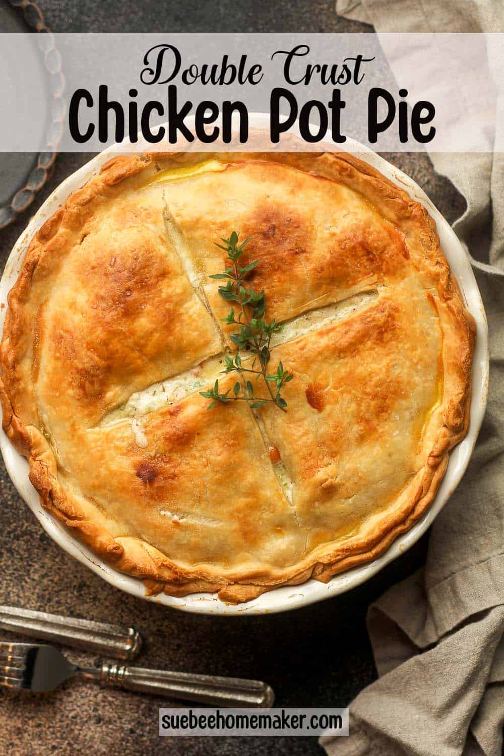 A white pie plate with a whole double crust chicken pot pie.