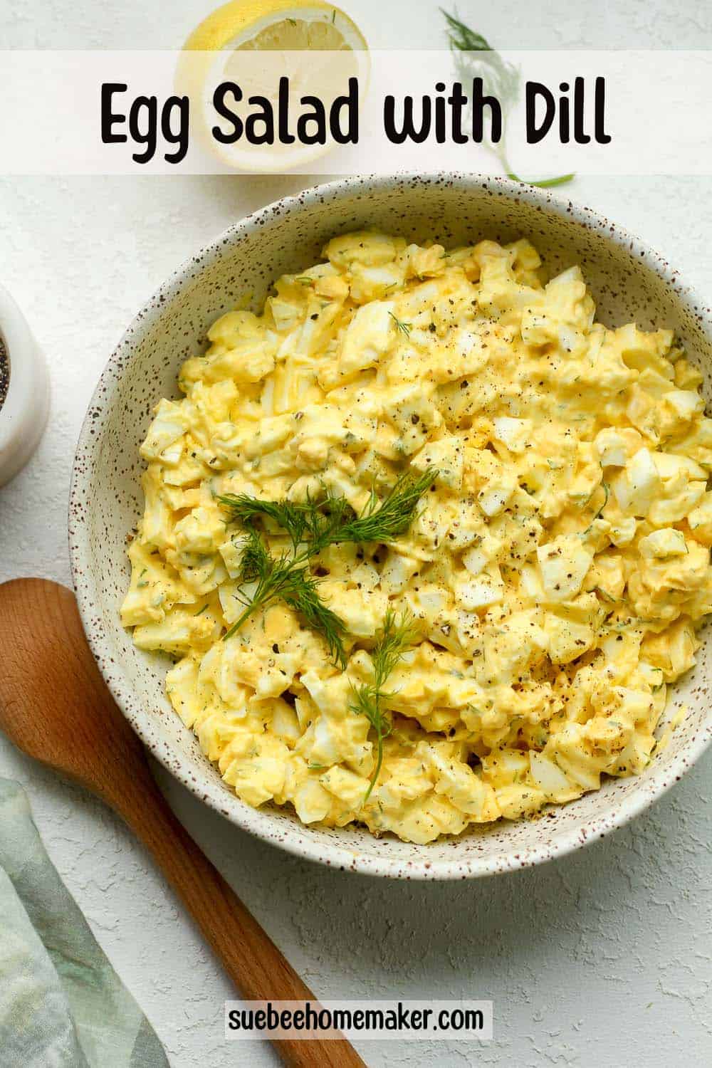A bowl of egg salad with dill.