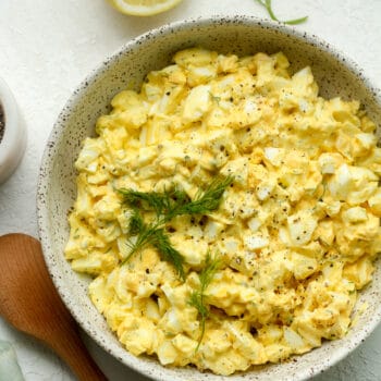 A bowl of creamy egg salad with dill.