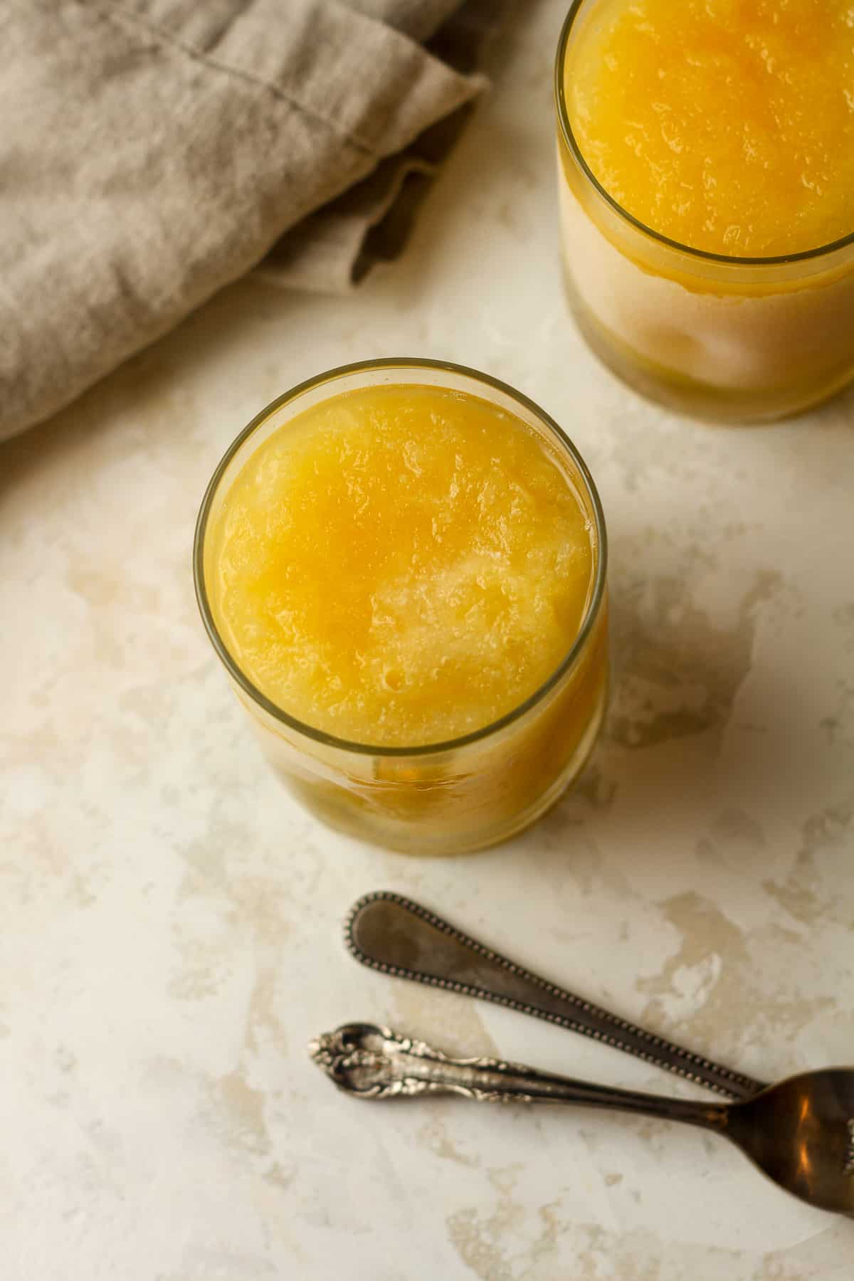 Two slushies made with vodka and orange juice concentrate.