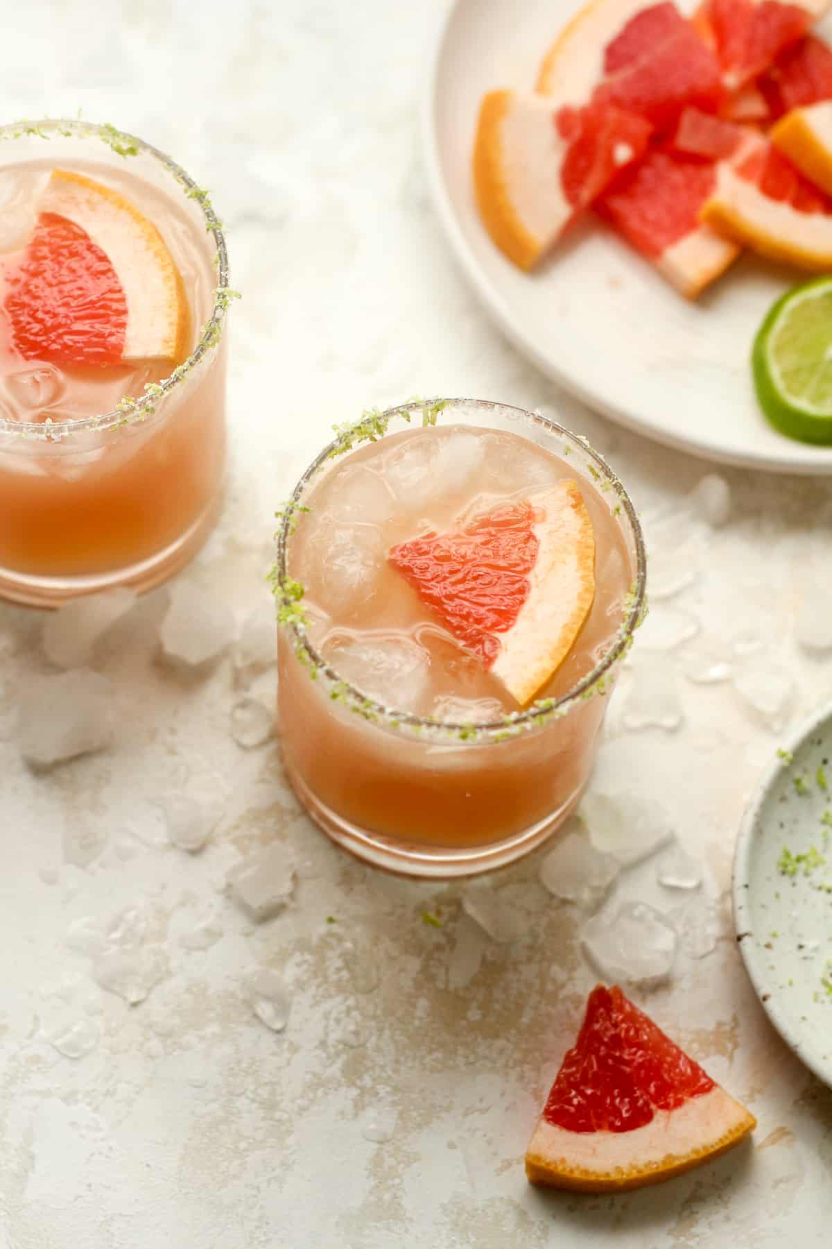 Two glasses of paloma with slices of grapefruit.