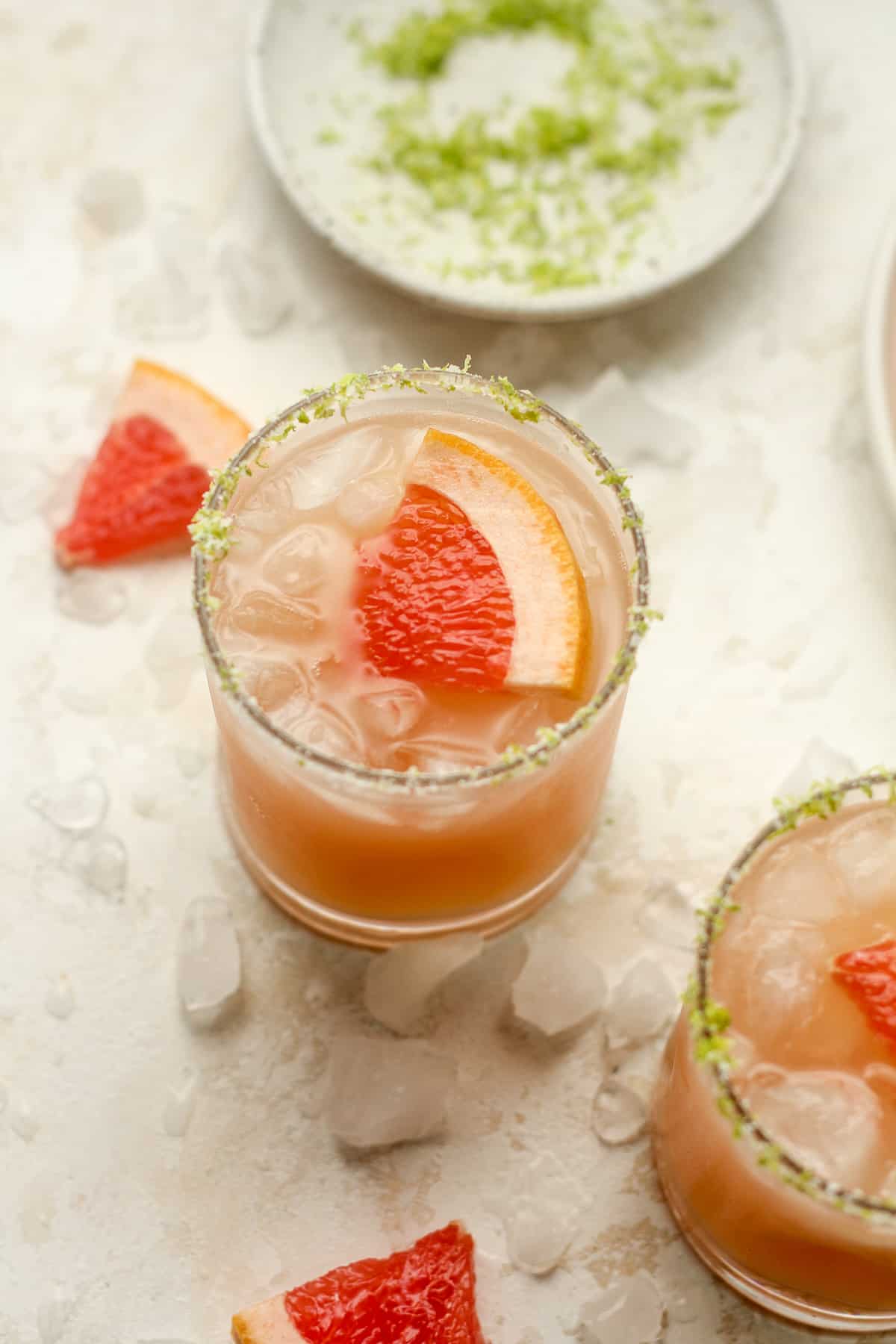 Overhead view of two glasses of grapefruit palomas.
