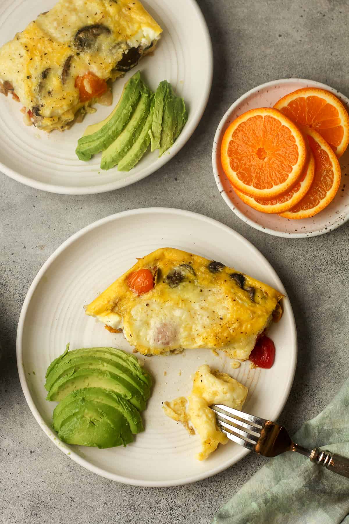 Overhead view of two pieces of veggie frittata with sliced avocado.