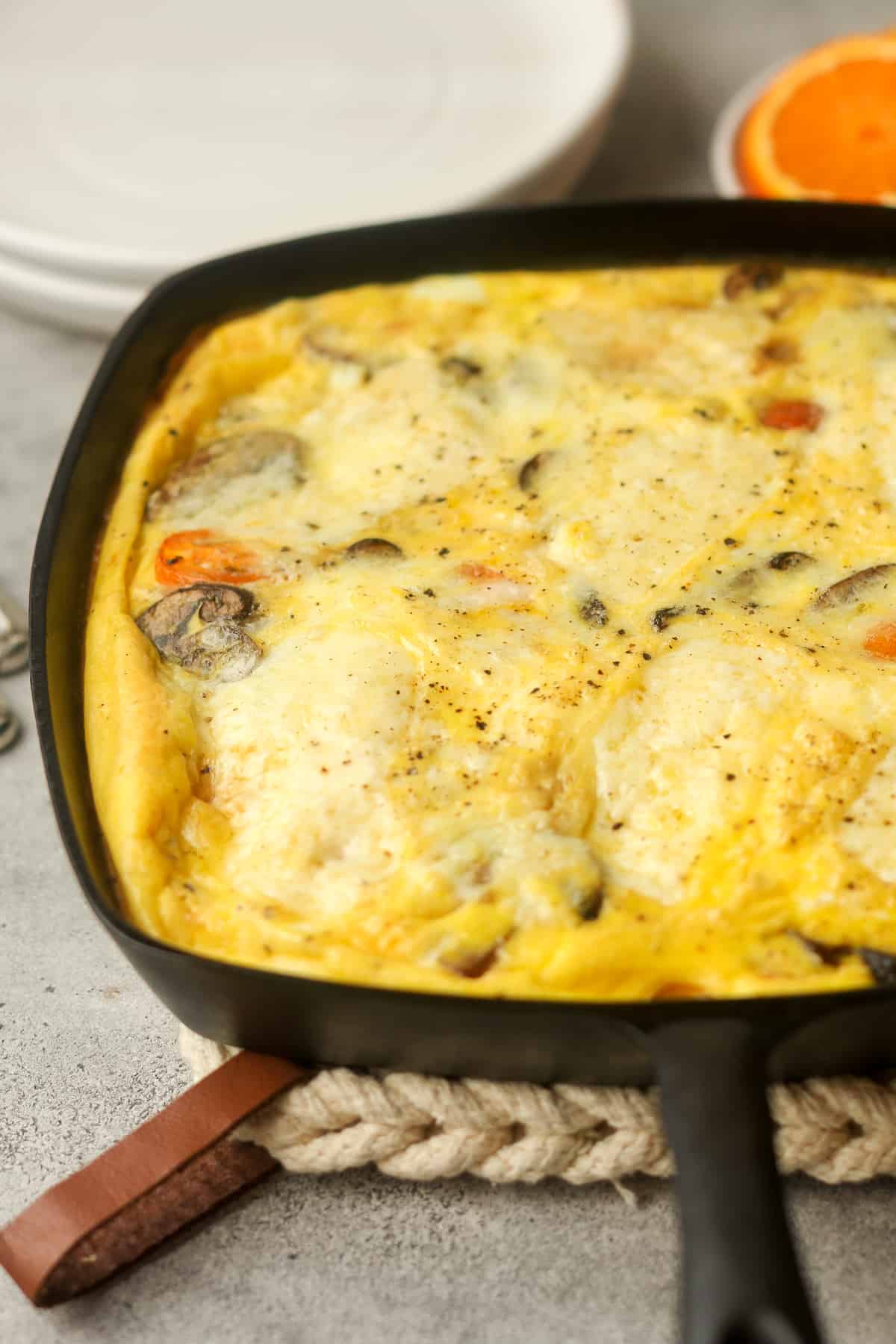 Side view of a cast iron skillet with veggie frittata.