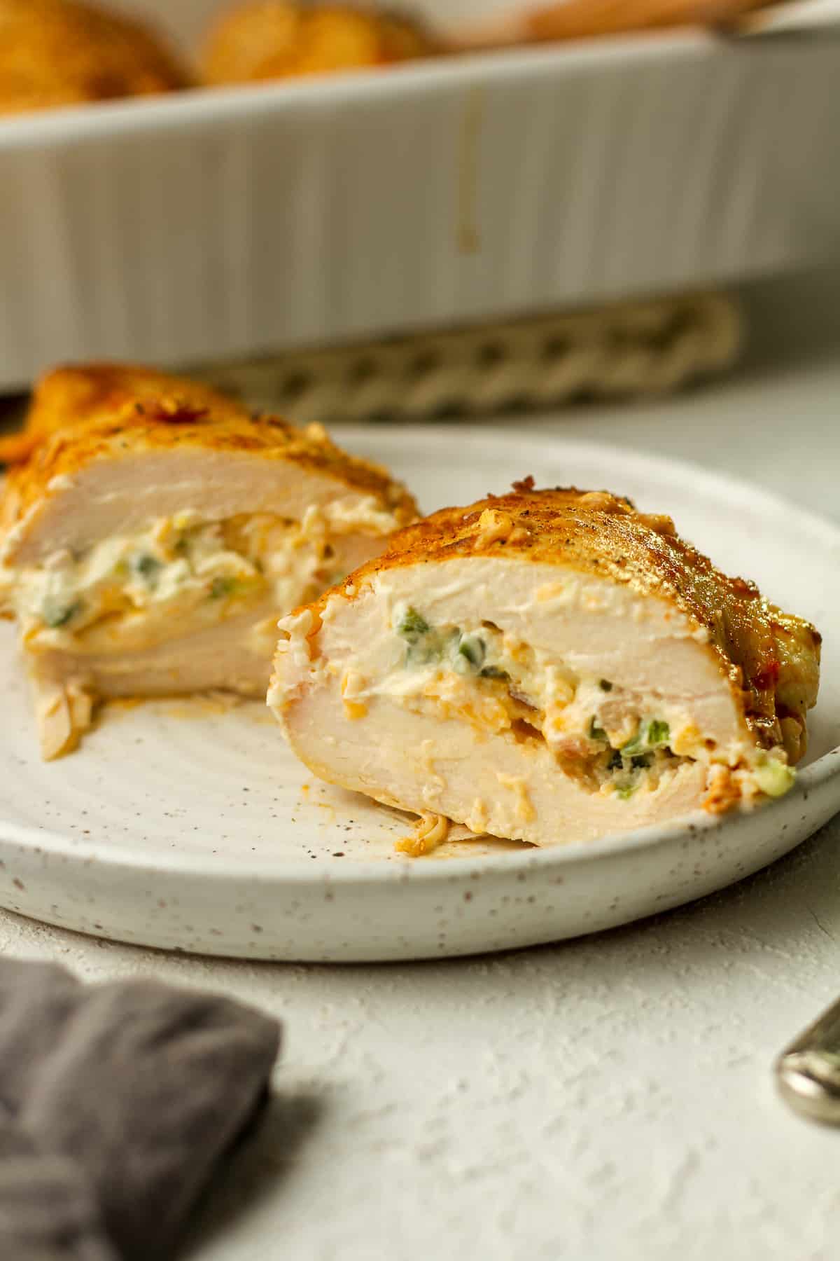 Side view of a halved stuffed chicken breast.