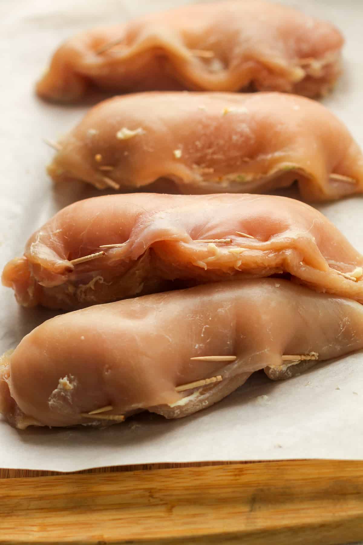 Side view of stuffed breasts, secured with toothpicks.