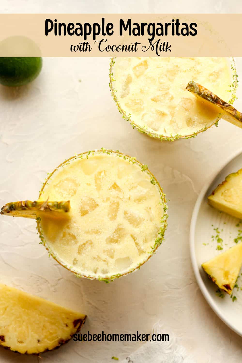 Overhead view of two pineapple margaritas with coconut milk.