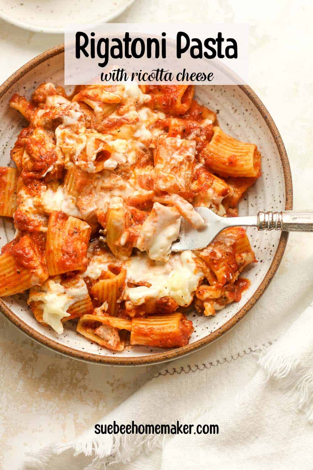 A serving of rigatoni pasta with ricotta cheese.