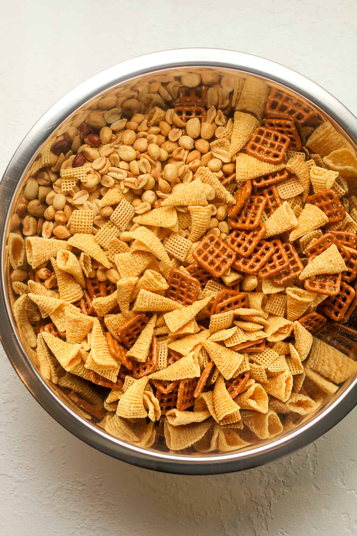 A large bowl of the chex mix dry ingredients.