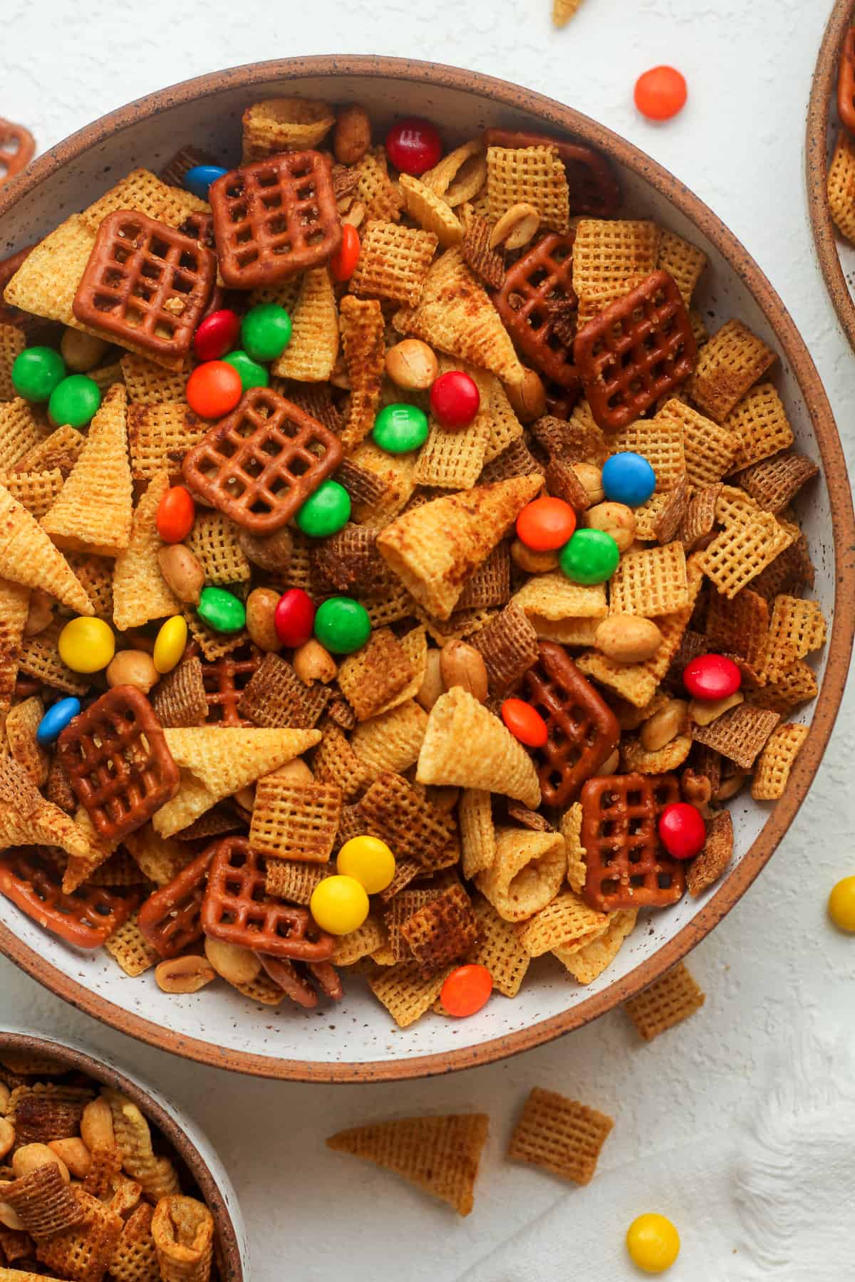 Closeup on a bowl of chex mix with m&ms.