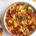 A bowl of the spicy chex mix with m&ms.